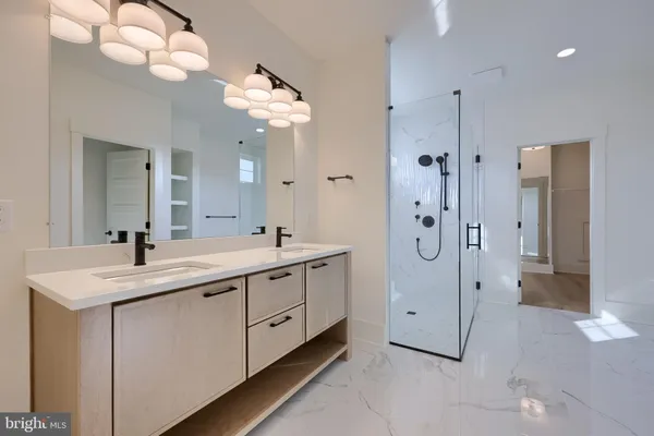 a spacious bathroom with a double vanity sink mirror and shower