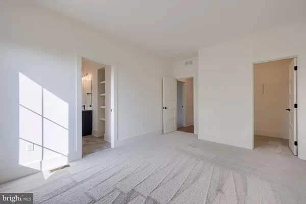 a view of empty room with wooden floor and cabinet