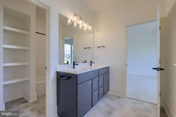 a bathroom with a double vanity sink and mirror