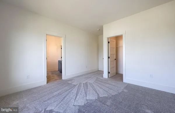 an empty room with closet and wooden floor