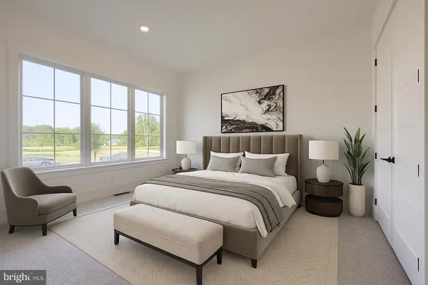 a spacious bedroom with a bed and a couch
