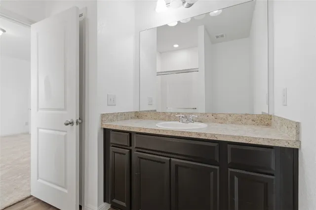 a view of a small space with wooden floor and a window