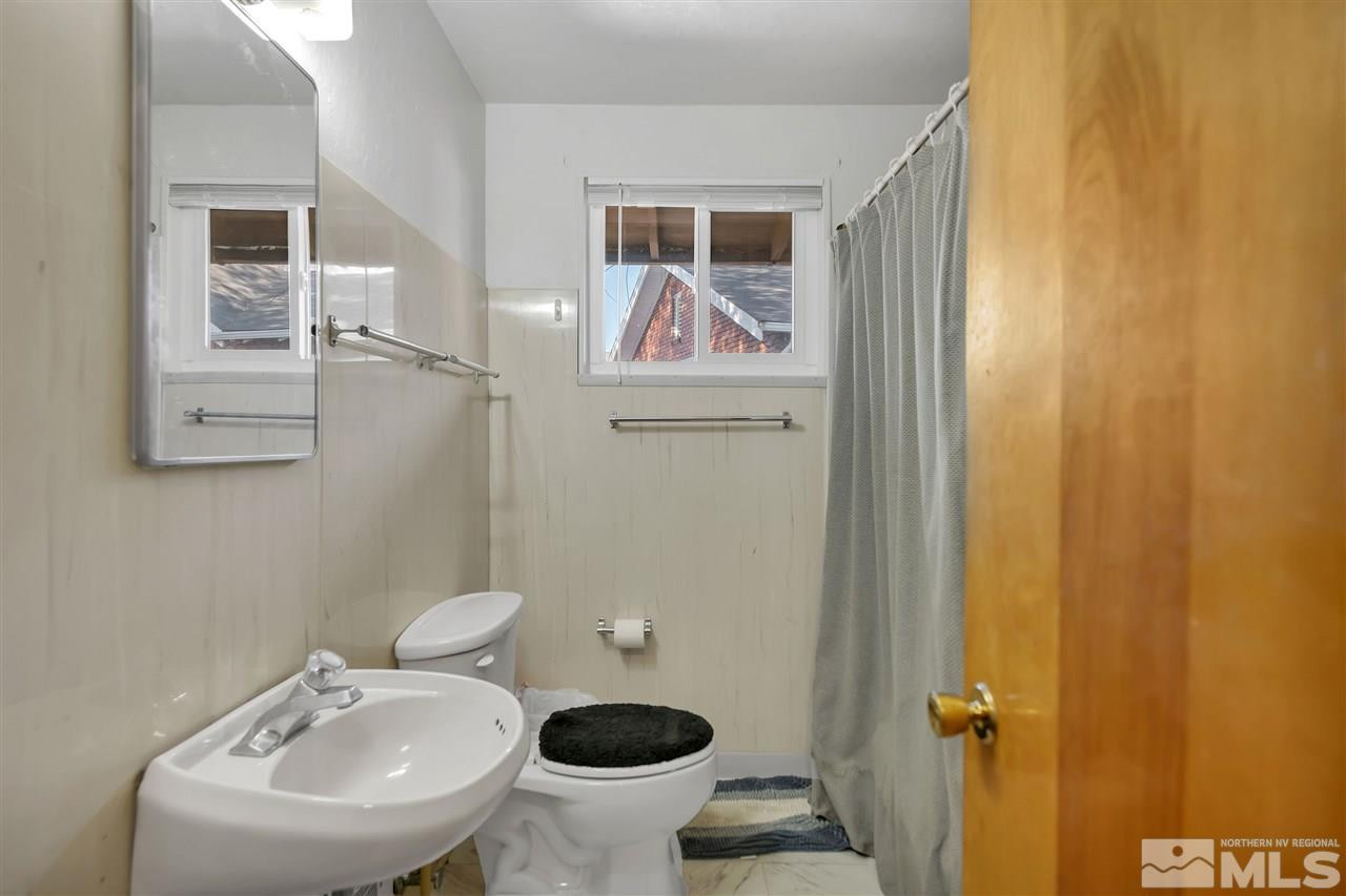 1135 The Strand Reno, NV 89503 - Photo 26 of 33 a bathroom with a sink a toilet and mirror