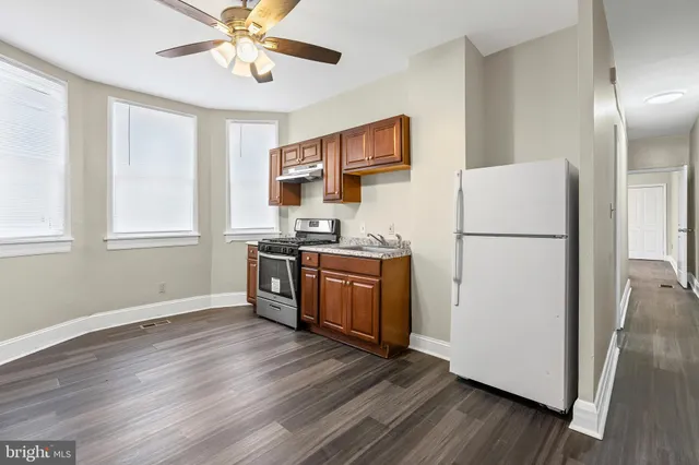a kitchen with stainless steel appliances a stove a sink and a refrigerator