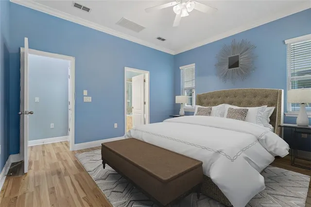 a bedroom with a bed and a ceiling fan