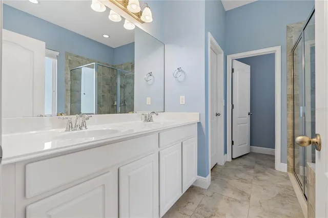 a bathroom with a double vanity sink and mirror