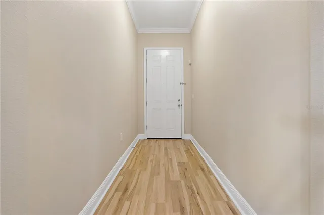 a view of a hallway with wooden floor