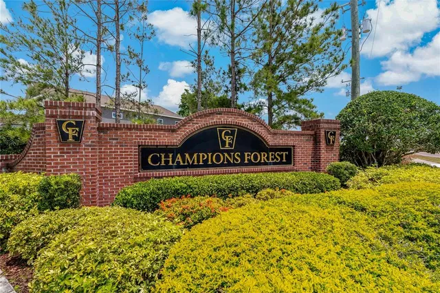 a sign that is sitting in front of flowers