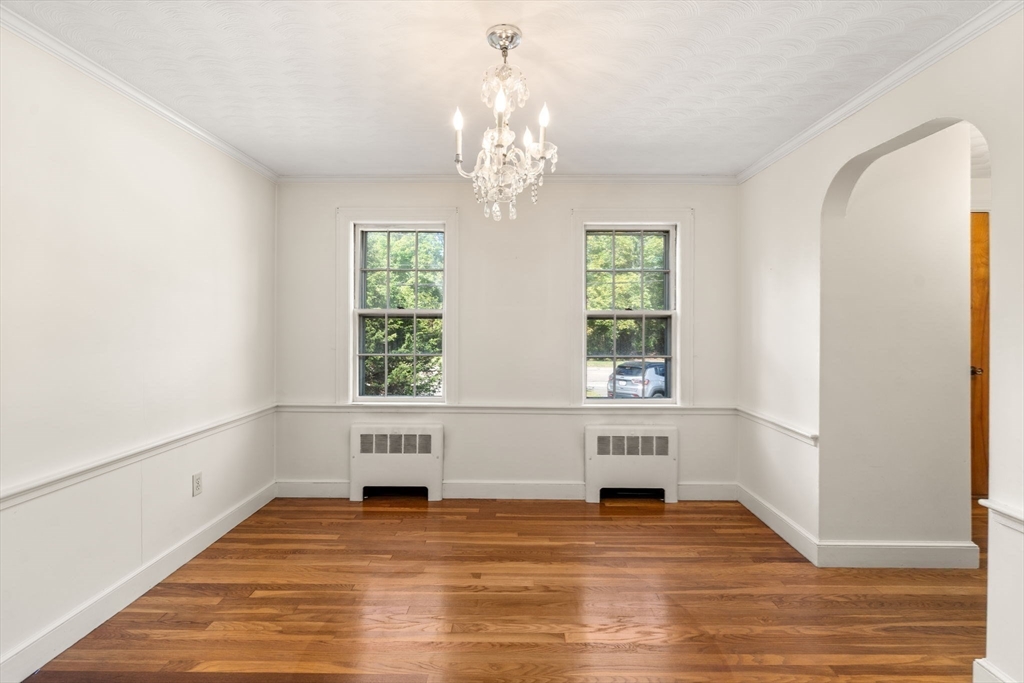 795 Brook Road Milton, MA 02186 - Photo 8 of 24 a view of an empty room with a window and wooden floor