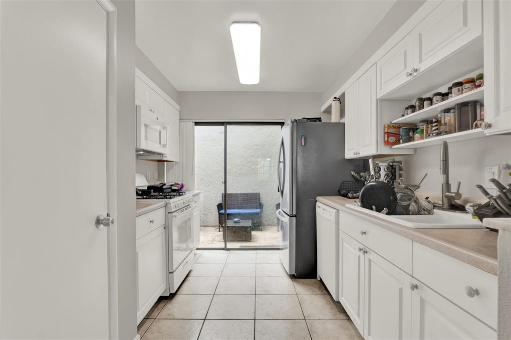 212 Perth Court Winter Springs, FL 32708 - Photo 12 of 57 a kitchen with stainless steel appliances a sink stove and cabinets