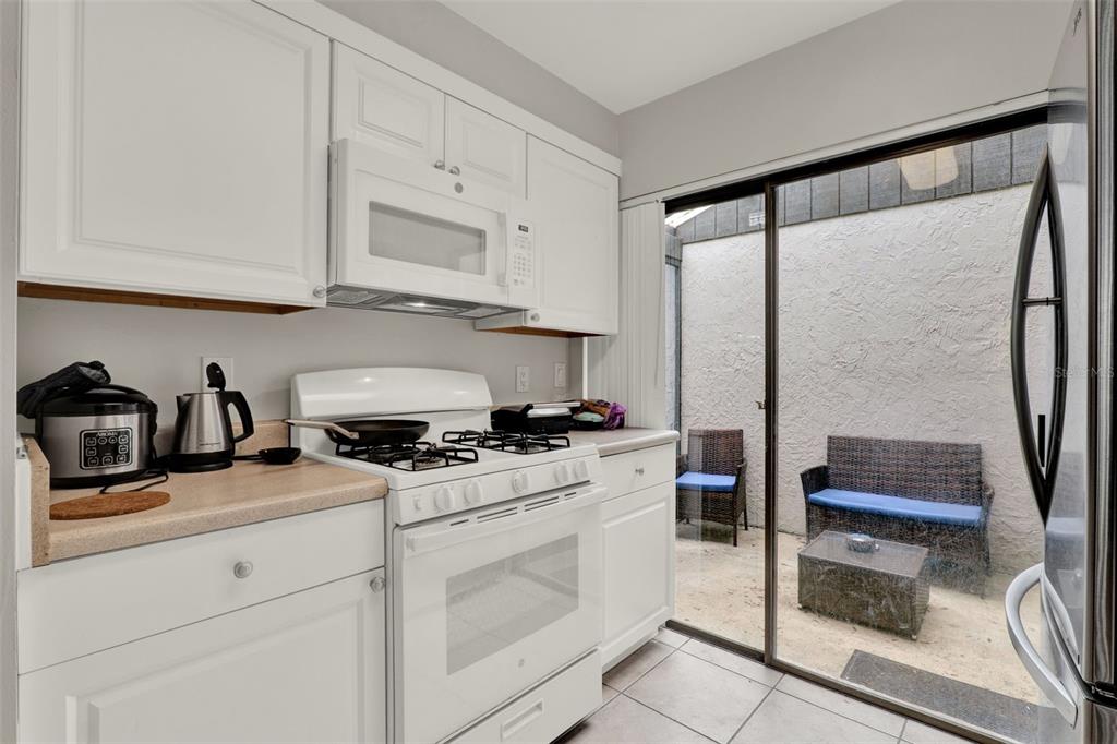 212 Perth Court Winter Springs, FL 32708 - Photo 14 of 57 a kitchen with stainless steel appliances granite countertop a stove a sink and a refrigerator