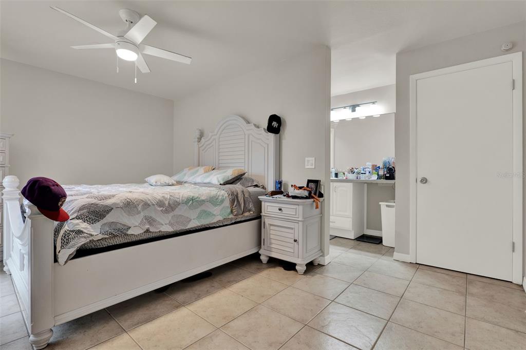 212 Perth Court Winter Springs, FL 32708 - Photo 17 of 57 a bedroom with a bed and cabinets