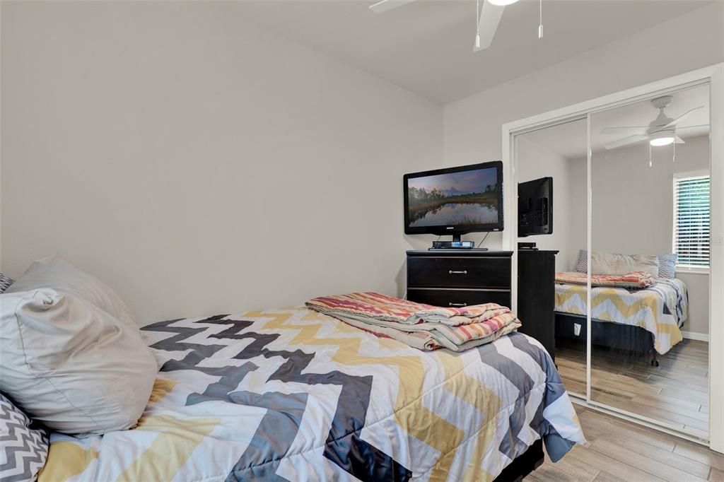 212 Perth Court Winter Springs, FL 32708 - Photo 19 of 57 a bedroom with a bed and flat tv screen