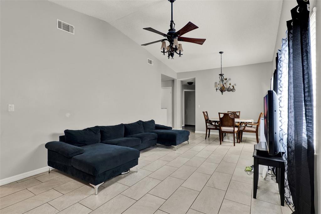 212 Perth Court Winter Springs, FL 32708 - Photo 35 of 57 a living room with furniture and a chandelier
