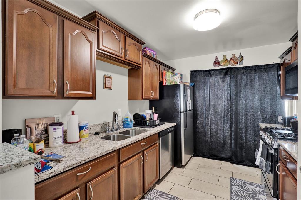 212 Perth Court Winter Springs, FL 32708 - Photo 42 of 57 a kitchen with stainless steel appliances granite countertop a refrigerator and a sink