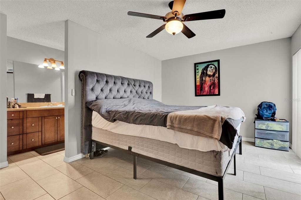 212 Perth Court Winter Springs, FL 32708 - Photo 44 of 57 a bedroom with a bed and cabinets