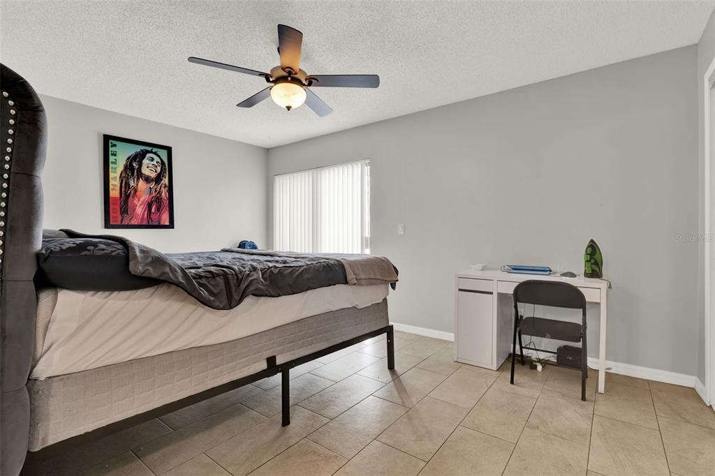 212 Perth Court Winter Springs, FL 32708 - Photo 45 of 57 a bedroom with a bed and a chair