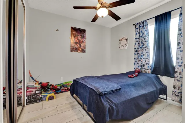 a view of a hallway with a livingroom and a bathroom