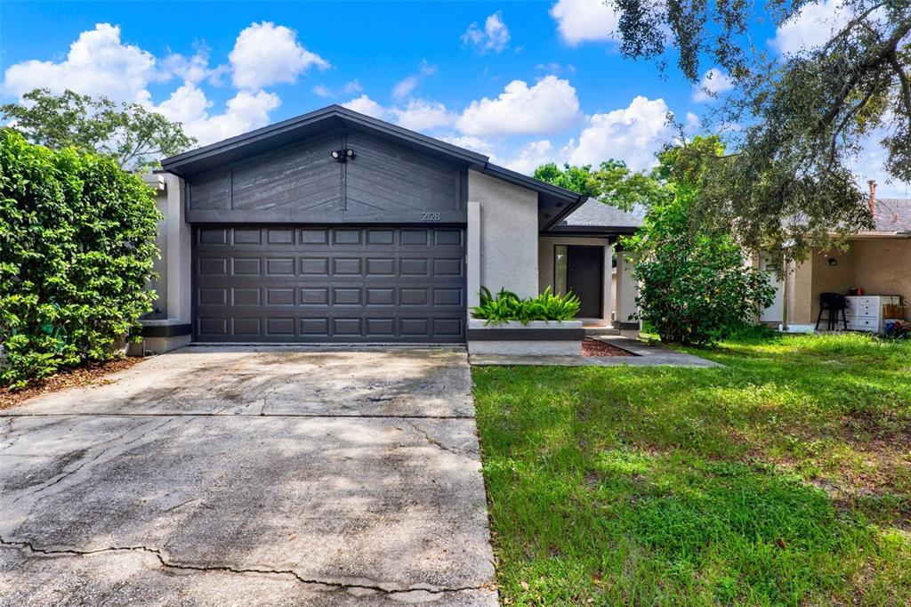 212 Perth Court Winter Springs, FL 32708 - Photo 5 of 57 a front view of a house with a yard and garage