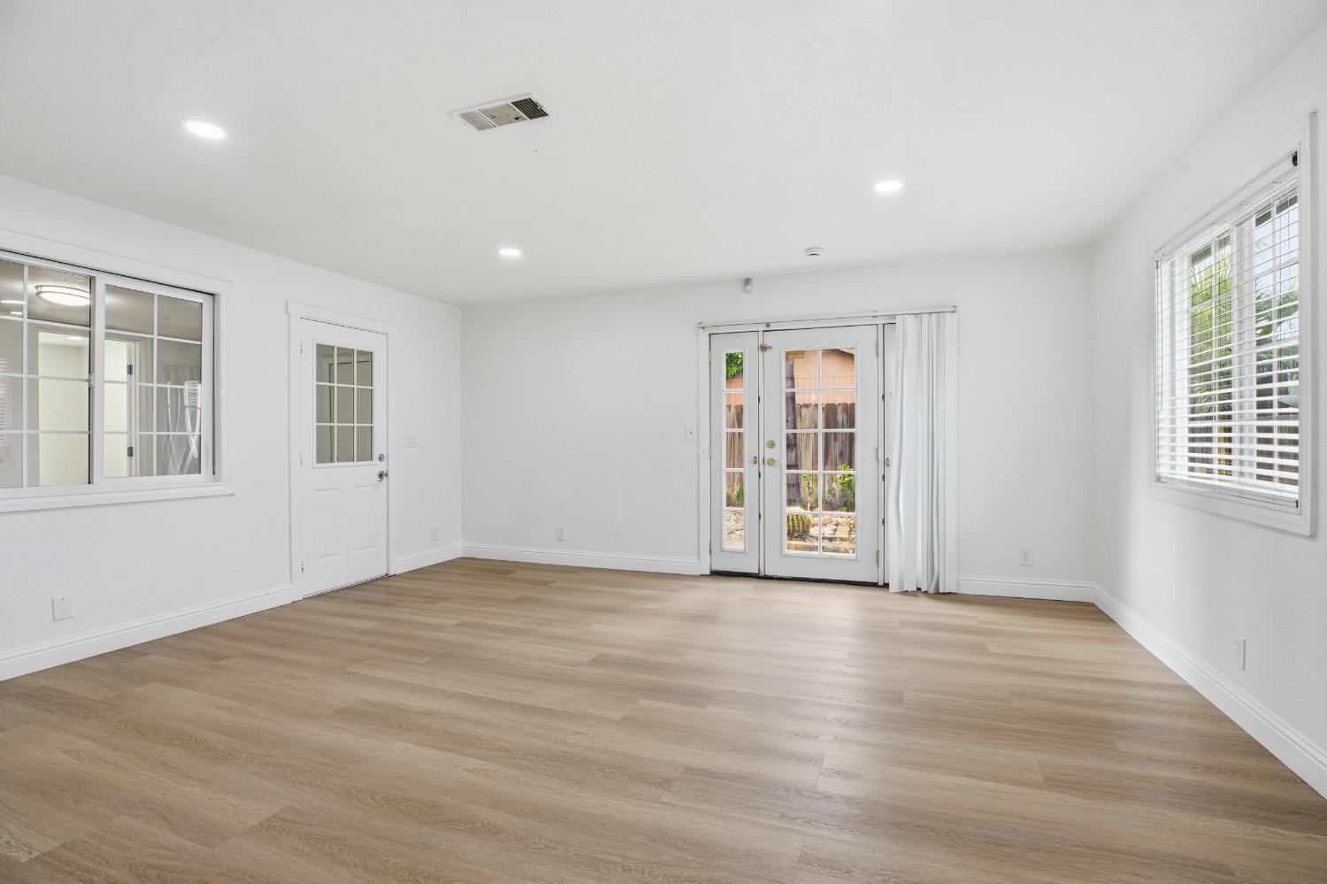 3020 Trudi Way Modesto, CA 95354 - Photo 11 of 24 a view of an empty room with wooden floor and a window