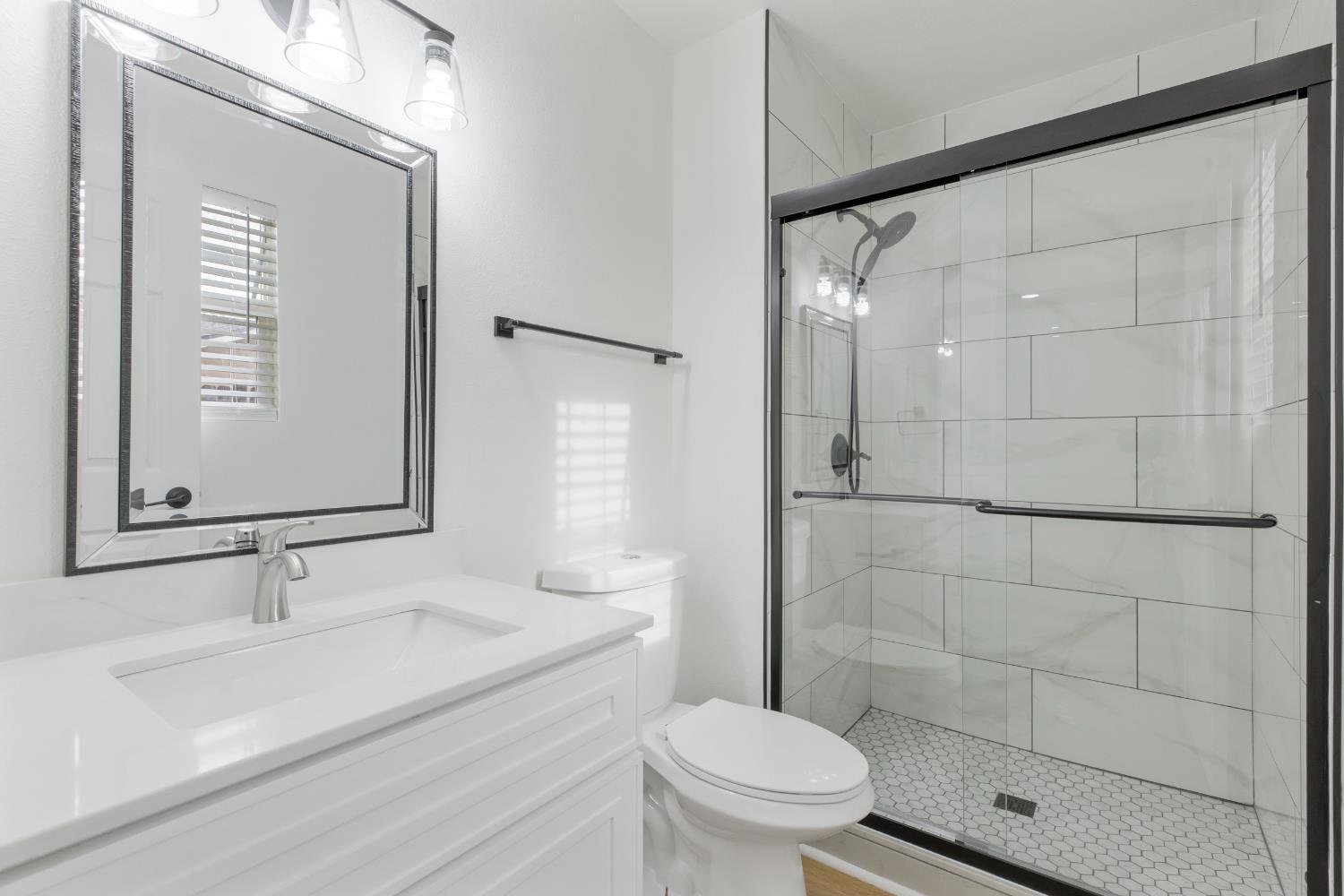 3020 Trudi Way Modesto, CA 95354 - Photo 13 of 24 a bathroom with a sink and a mirror
