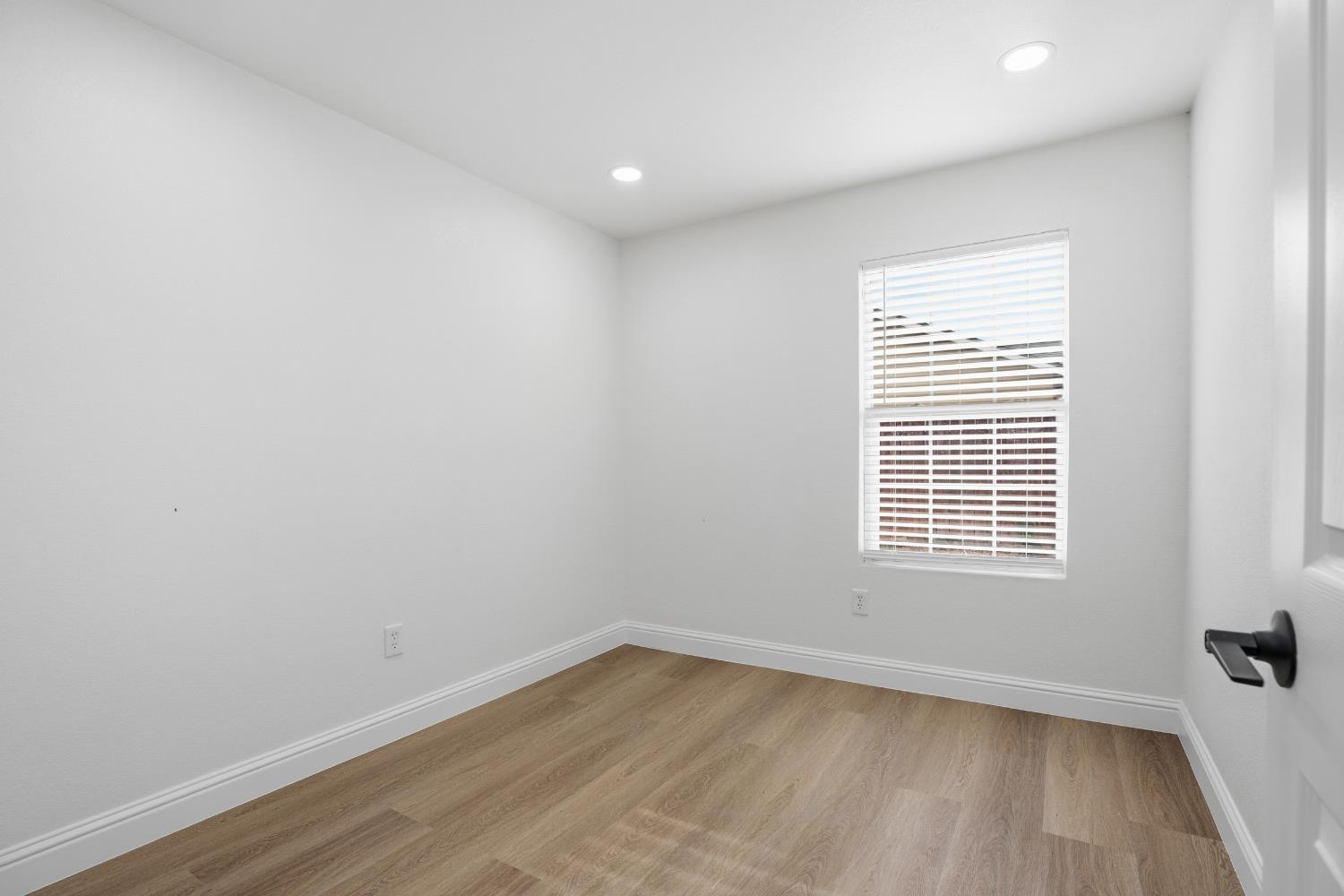 3020 Trudi Way Modesto, CA 95354 - Photo 19 of 24 a view of an empty room with wooden floor and a window