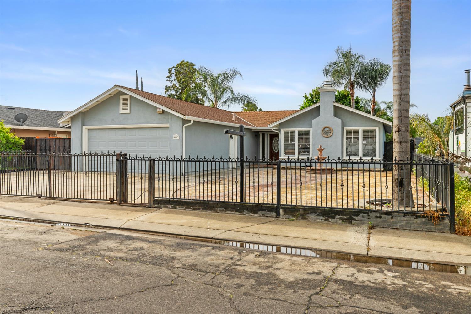 3020 Trudi Way Modesto, CA 95354 - Photo 2 of 24 a view of a house with a small yard and wooden fence