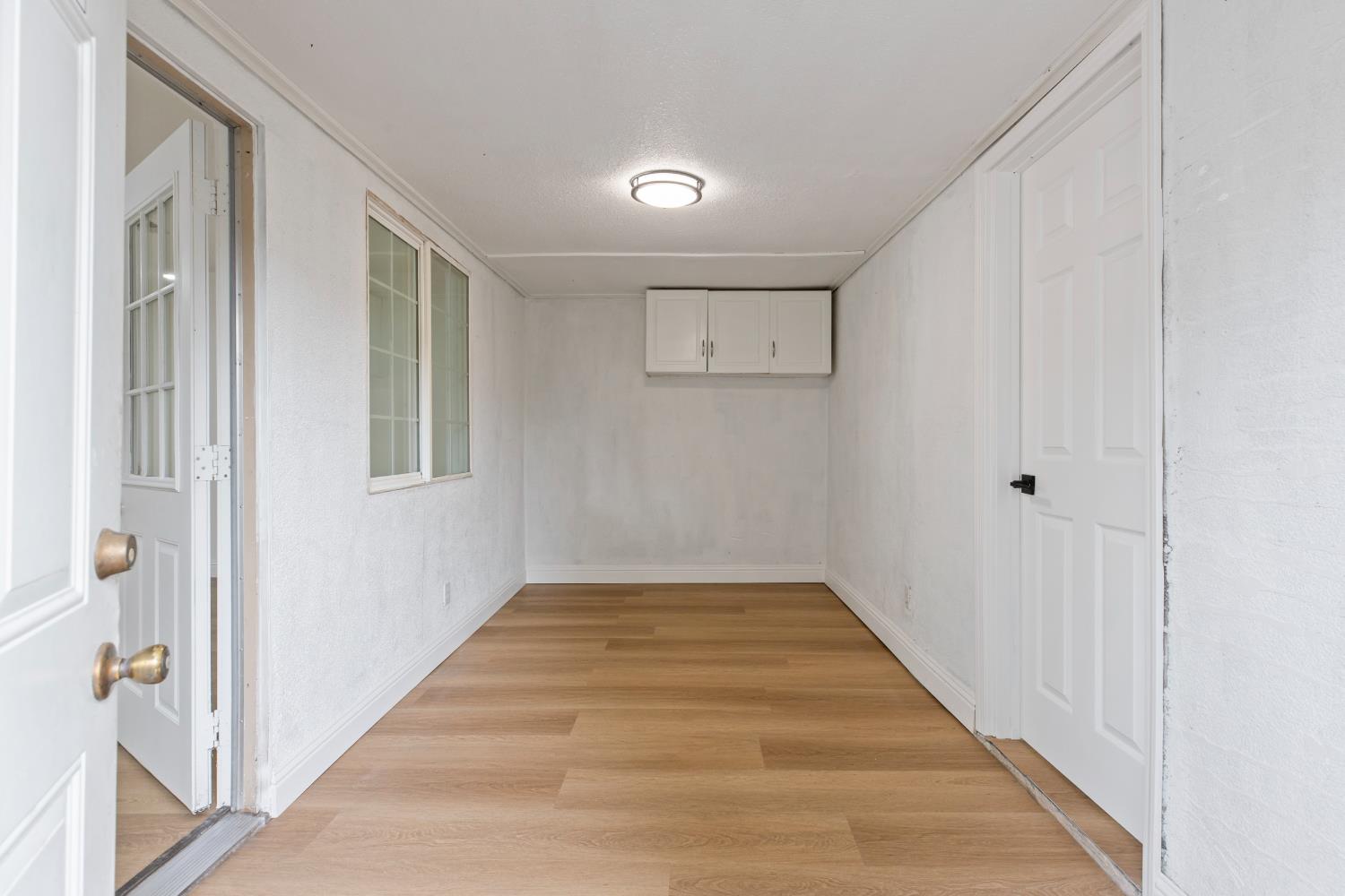3020 Trudi Way Modesto, CA 95354 - Photo 21 of 24 a view of an empty room with wooden floor and a window