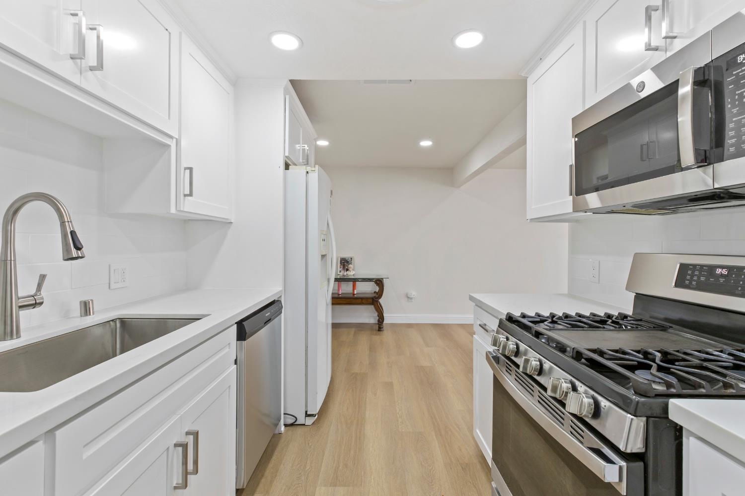 3020 Trudi Way Modesto, CA 95354 - Photo 6 of 24 a kitchen with stainless steel appliances a sink a stove and cabinets