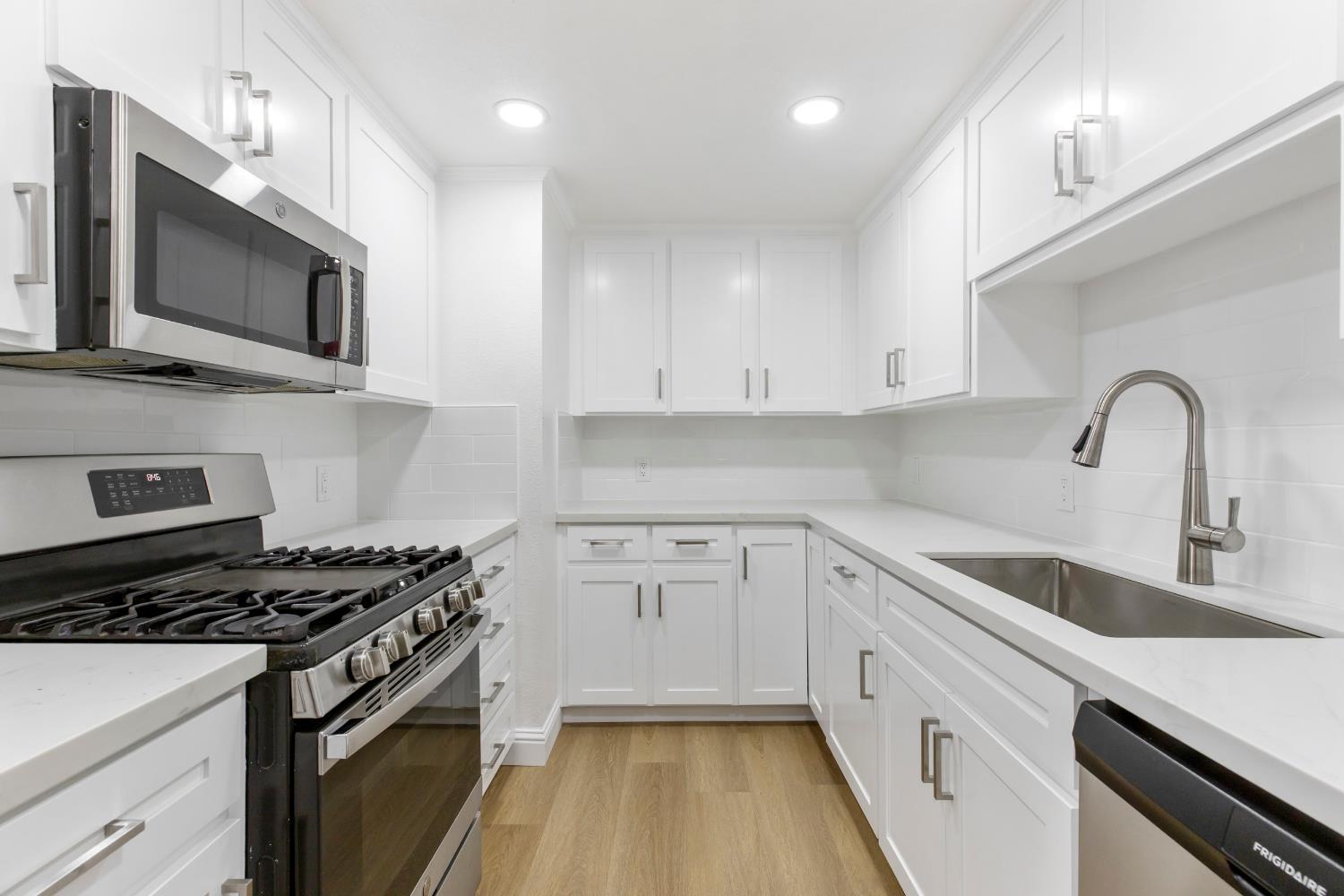 3020 Trudi Way Modesto, CA 95354 - Photo 7 of 24 a kitchen with white cabinets stainless steel appliances and sink