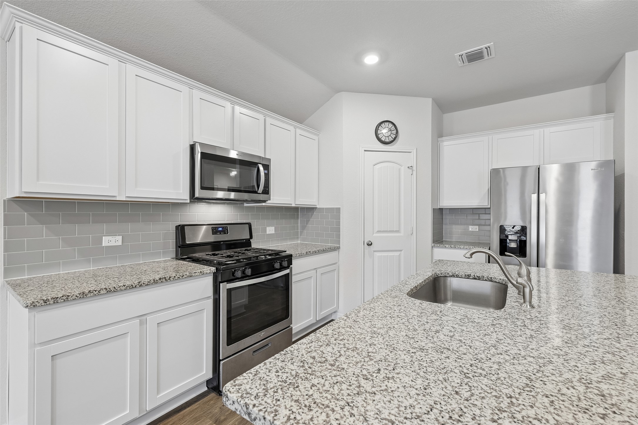 19805 Abigail Fillmore Road Manor, TX 78653 - Photo 12 of 40 A well-lit kitchen featuring stainless steel appliances and abundant counter space for culinary endeavors.