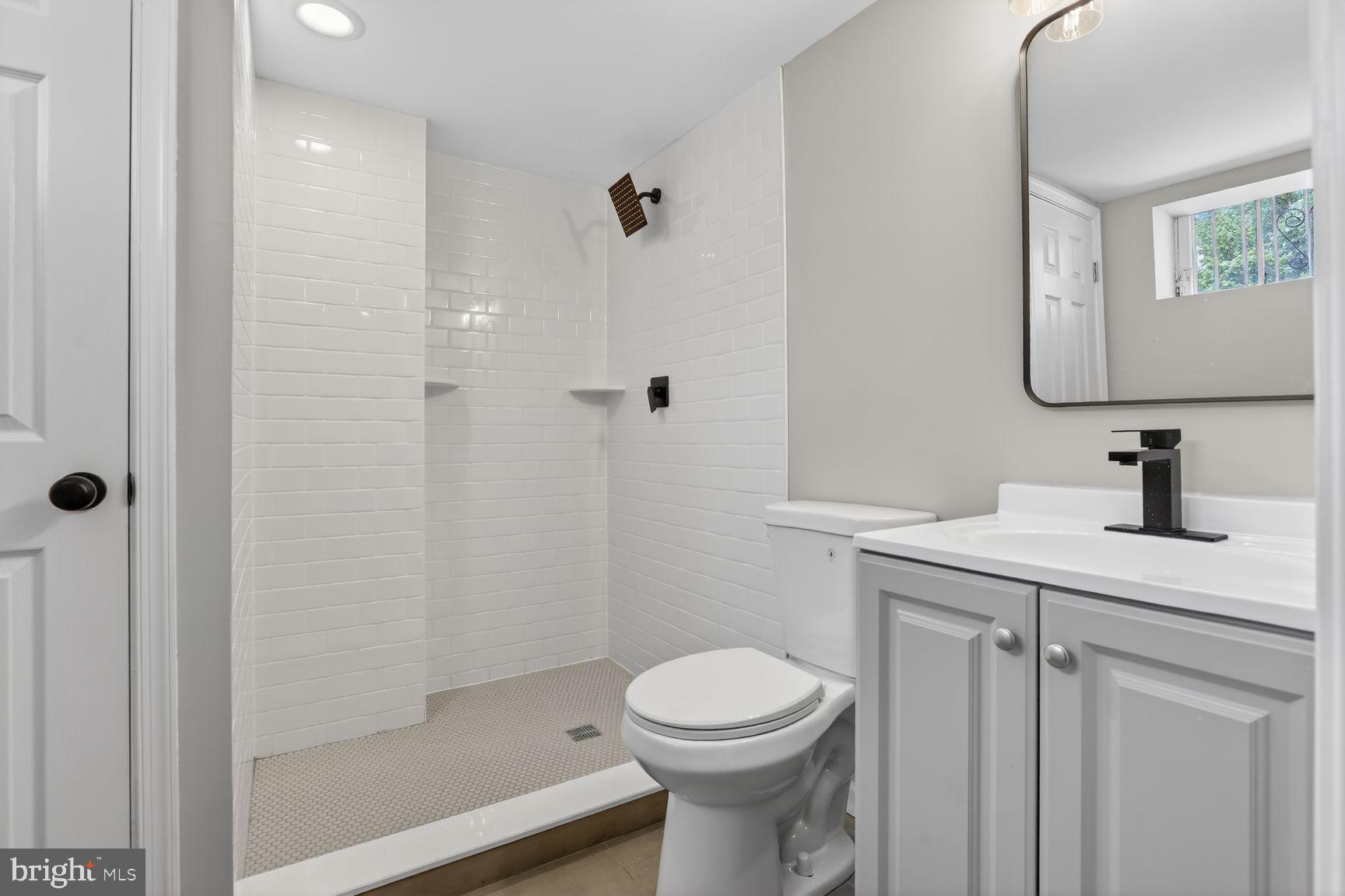 315 East Cold Spring Lane Baltimore, MD 21212 - Photo 9 of 25 a bathroom with a sink a toilet and shower