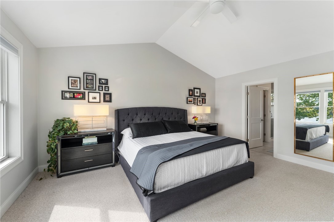 297 Gorton Lake Boulevard Warwick, RI 02886 - Photo 19 of 38 Vaulted ceilings in the main bedroom suite offer a spacious and airy feeling