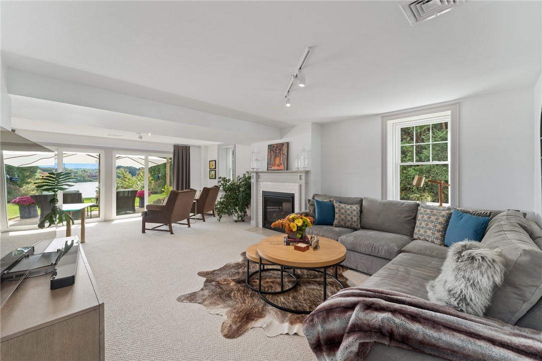 297 Gorton Lake Boulevard Warwick, RI 02886 - Photo 29 of 38 Warm and inviting, the lower level has a fireplace ready for winter