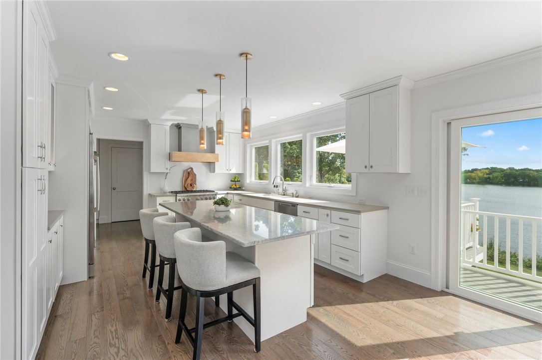 297 Gorton Lake Boulevard Warwick, RI 02886 - Photo 9 of 38 The kitchen island is perfect for gathering while enjoying the view