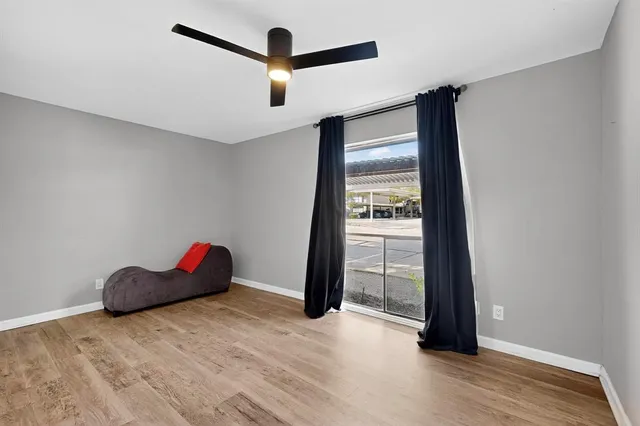 an empty room with closet and windows