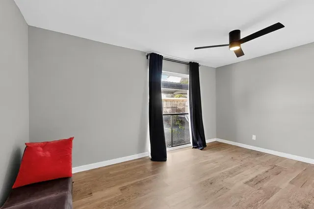an empty room with closet and windows