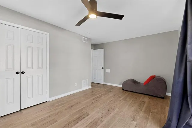 a view of empty room with wooden floor
