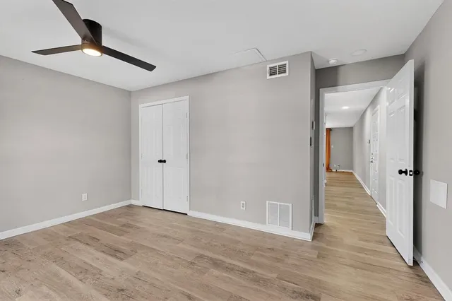 a view of an empty room with wooden floor