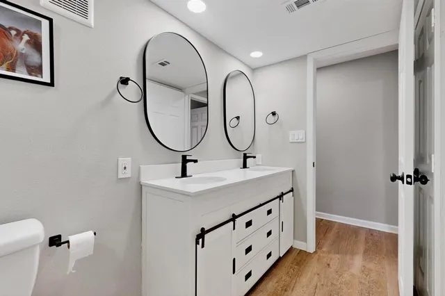 a bathroom with a sink double vanity and a mirror