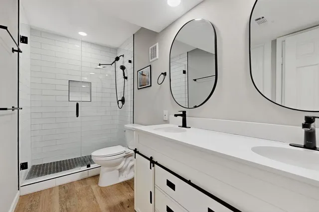 a bathroom with a toilet a sink and mirror