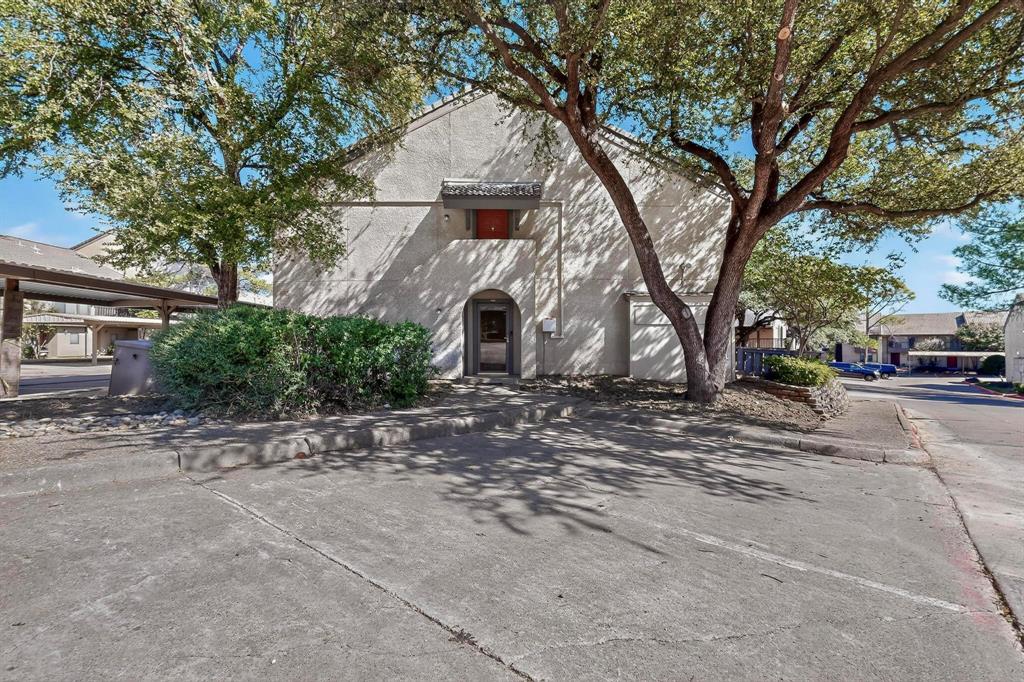 4535 North O'Connor Road, Unit 1210 Irving, TX 75062 - Photo 2 of 20 a front view of a house with a yard and garage