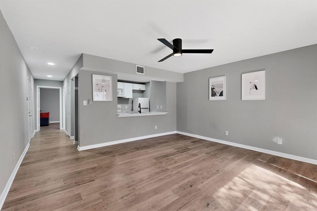 4535 North O'Connor Road, Unit 1210 Irving, TX 75062 - Photo 6 of 20 a view of a big room with wooden floor and a ceiling fan