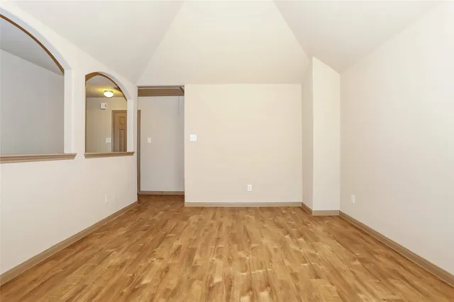a view of a room with wooden floor and white doors