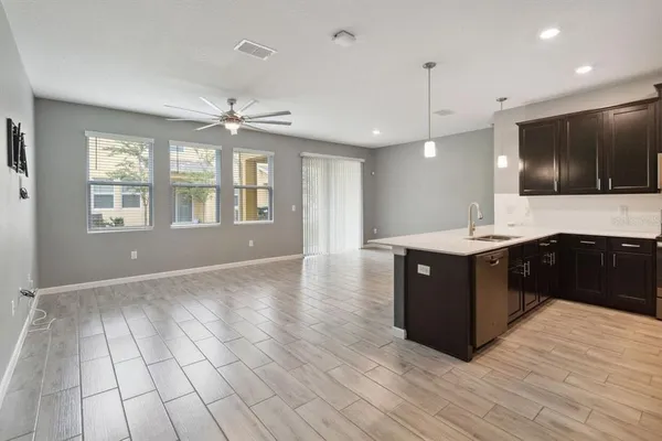 a large kitchen with kitchen island a sink stainless steel appliances and cabinets