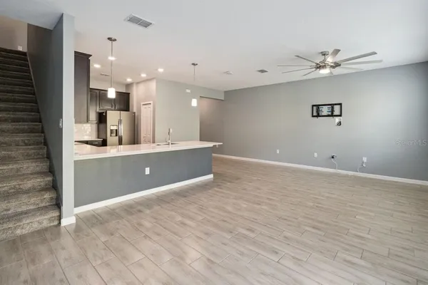 a view of a kitchen with a sink and a refrigerator
