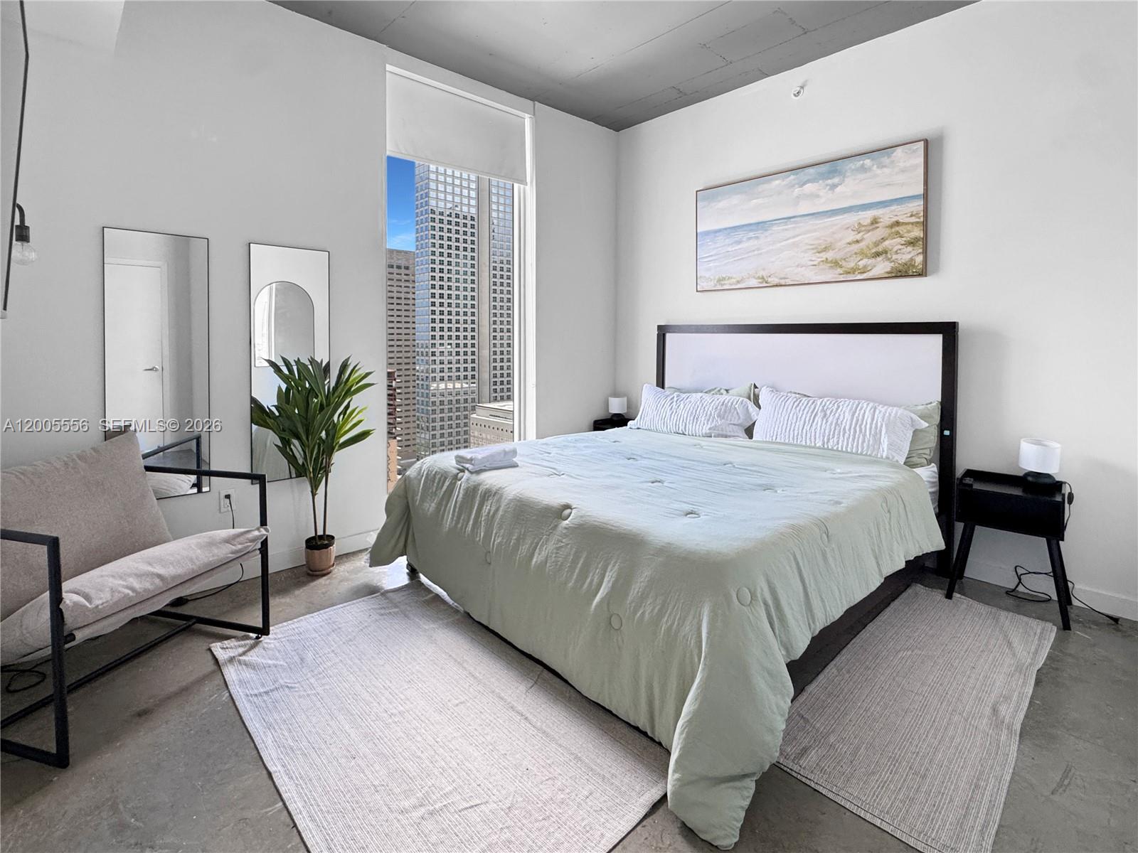 151 Southeast 1st Street, Unit 2702 Miami, FL 33131 - Photo 11 of 29 a bedroom with a bed and a couch