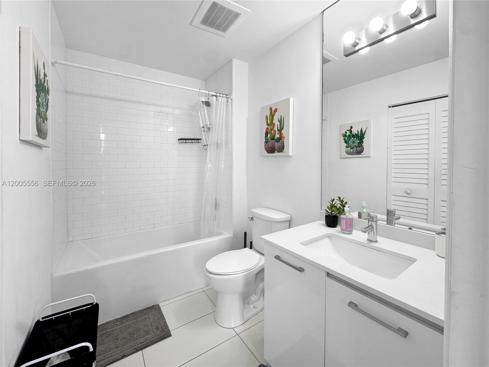 151 Southeast 1st Street, Unit 2702 Miami, FL 33131 - Photo 15 of 29 a bathroom with a sink a toilet and shower