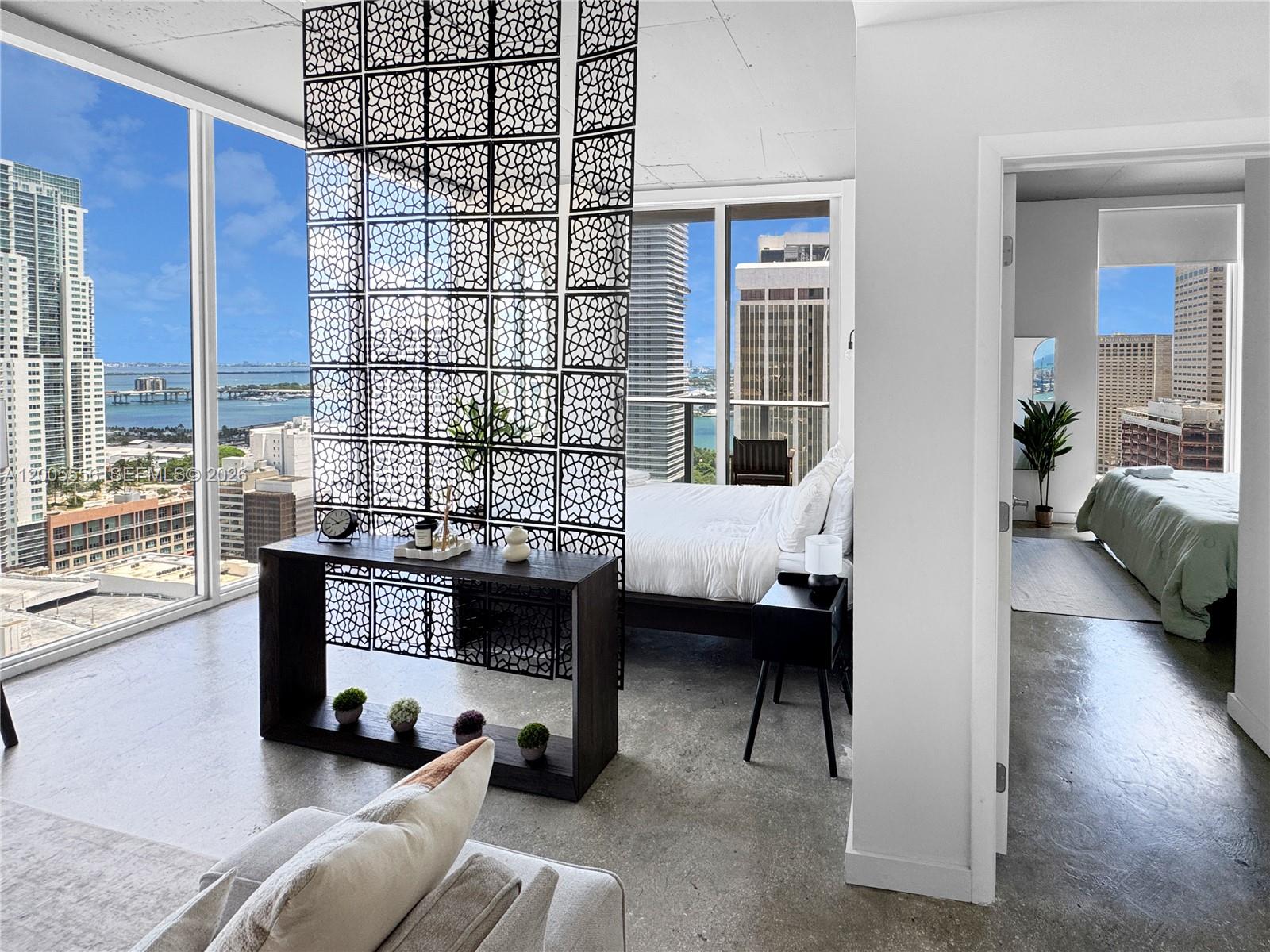 151 Southeast 1st Street, Unit 2702 Miami, FL 33131 - Photo 7 of 29 a living room with furniture and a large window