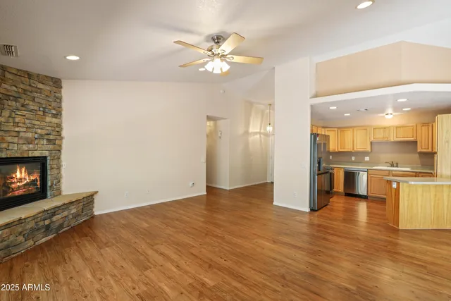 a view of kitchen with livingroom and wooden floor